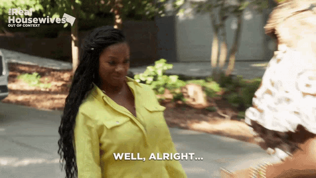 a woman in a yellow shirt that says well alright