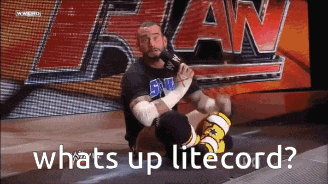 a wrestler is kneeling down in front of a sign that says whats up litecord