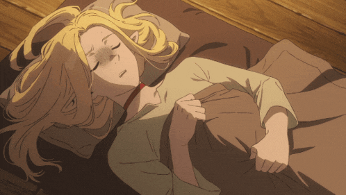 a woman with blonde hair is sleeping on a bed with her eyes closed