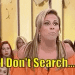 a woman is sitting in front of a crowd and says `` i don t search ... '' .