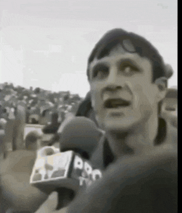 a man is speaking into a microphone that says ppn on it