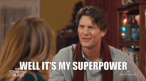 a man with a scarf around his neck is talking to a woman and says well it 's my superpower