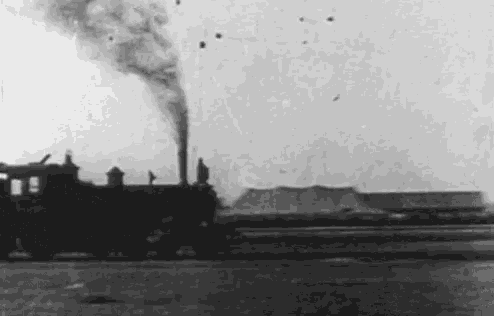 a black and white photo of a train with smoke coming out of it 's chimney .