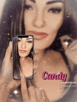 a woman is taking a picture of herself on a cell phone and the name candy is on the bottom right