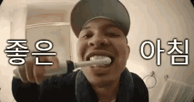 a man is brushing his teeth in a bathroom with a toothbrush .
