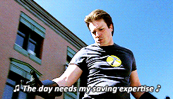 a man standing in front of a building with the words " the day needs my saving expertise " above him