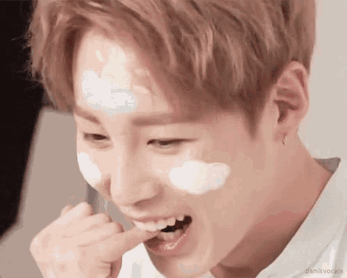 a close up of a person with a cloud on their face eating something .