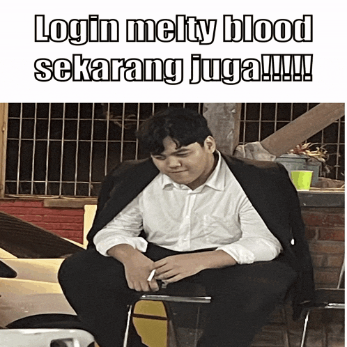 a man in a suit sits on a chair with the words login melty blood sekarang juga