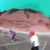 a blurry photo of a person riding a skateboard down a hill