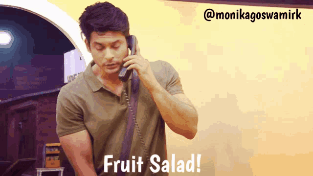 a man is talking on a phone with the words fruit salad written below him