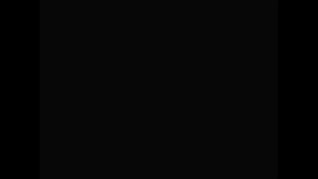 a video game screen shows a purple and orange flower with a black face
