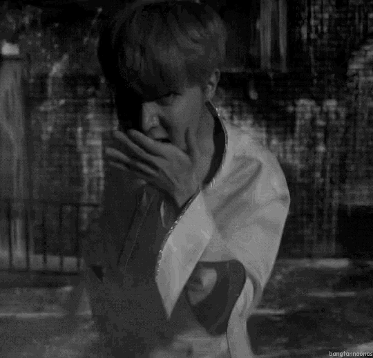 a black and white photo of a man in a white shirt .