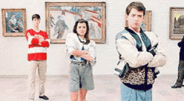 a group of people are standing in front of paintings with their arms crossed