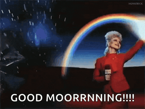 a woman in a red suit is holding a microphone in front of a rainbow and says good moorrnning !!!