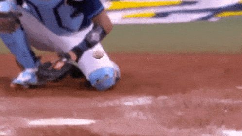 a baseball player catching a ball on a field