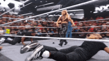 a wrestling ring with a sign that says nxt