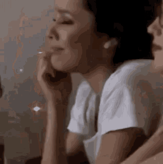 a woman in a white t-shirt is sitting next to a man in a white shirt .