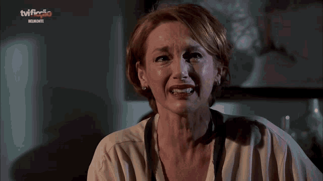a woman is crying in front of a tv that says tviflix on it