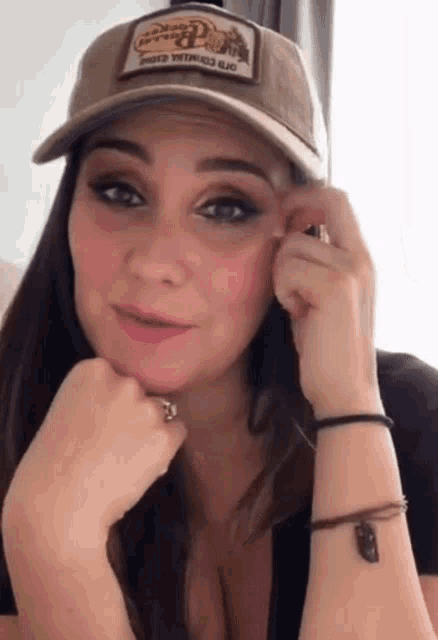 a woman wearing a hat with a patch on it that says ' beer ' on it