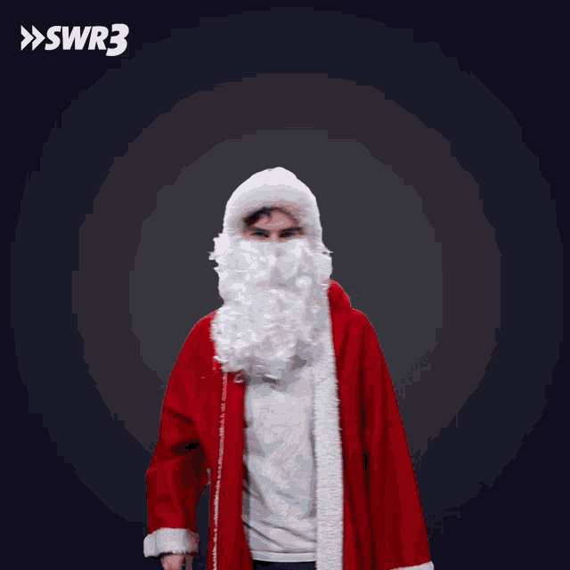 a man dressed in a santa claus costume is dancing in front of a swr3 logo