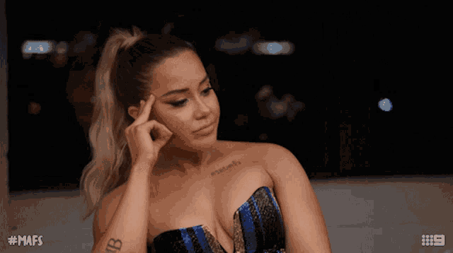 a woman with a tattoo on her arm has the hashtag # mafs