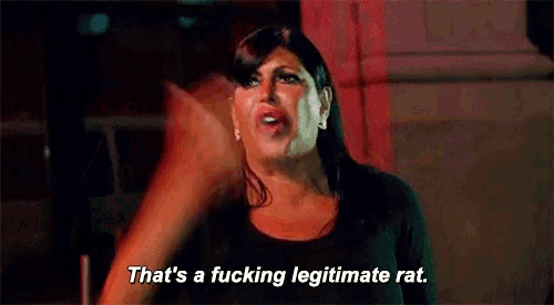 a woman is pointing at something and saying `` that 's a fucking legitimate rat '' .