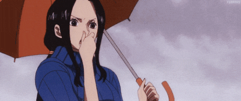 a woman is holding an orange umbrella and covering her nose