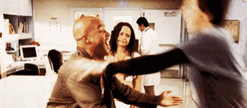 a man and a woman are hugging each other in a hospital .