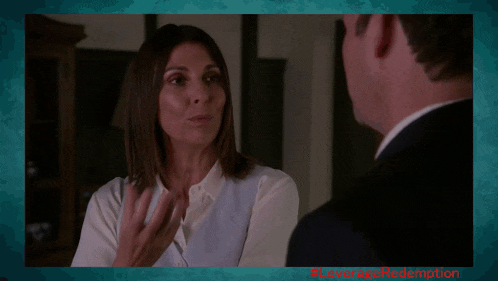 a woman in a white shirt is talking to a man in a suit with # leverage redemption written in red