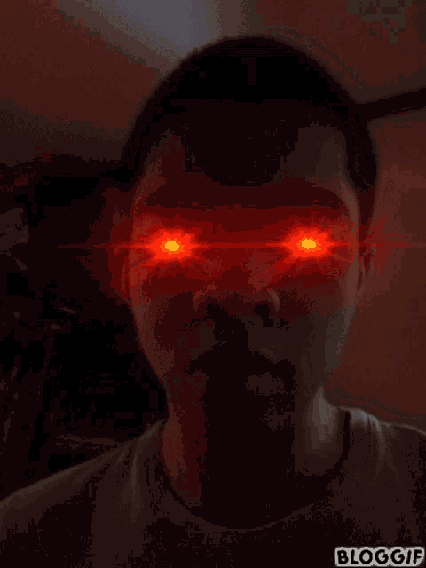 a man 's face is lit up with red lights and the words bloggif are on the bottom