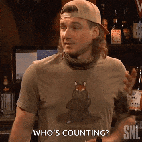 a man wearing a shirt that says ' who 's counting '