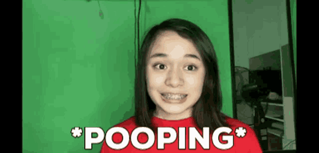 a girl with braces on her teeth says pooping in front of a green background