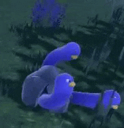 a blue stuffed animal with a yellow beak is swimming in the water in a video game .