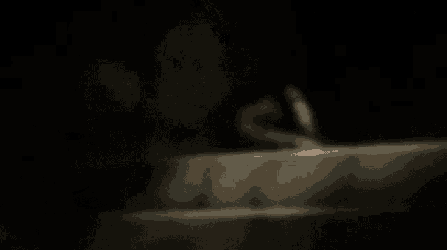 a hand is reaching out towards a large hand