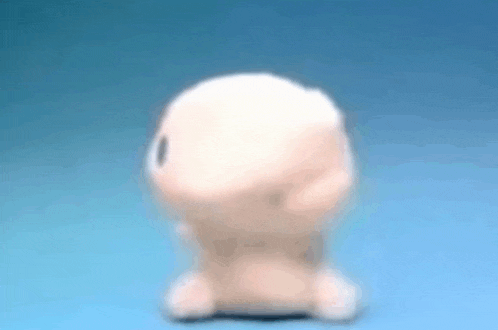 a stuffed animal is sitting on a blue surface with its head visible .