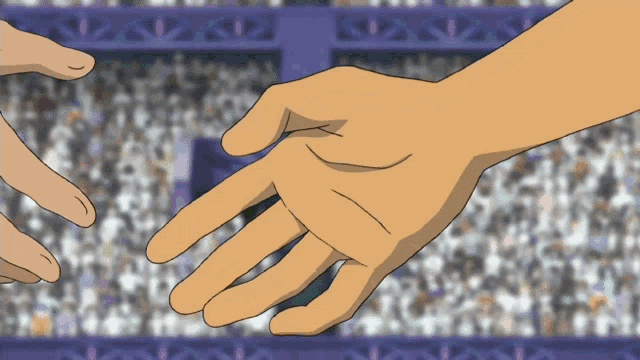 a couple of hands reaching out towards each other in front of a crowd