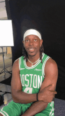 a man wearing a green jersey that says boston 4