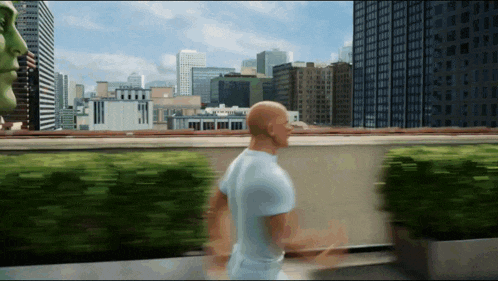 a man in a white shirt is running in front of a city