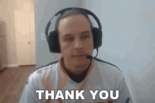 a man wearing headphones and a shirt that says thank you on it