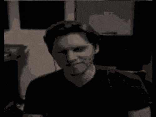 a pixelated image of a man and a green cartoon character with the letter t on it