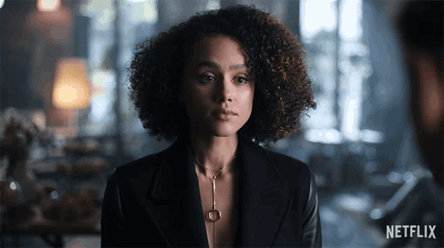 a woman with curly hair and a netflix logo on the bottom