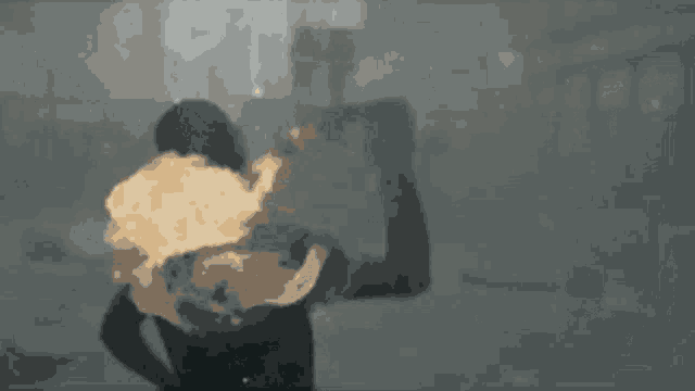 a man is walking down a street in the fog with a blurred background .