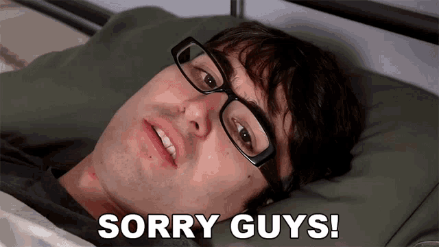 a man with glasses laying in bed with the words sorry guys written on the bottom