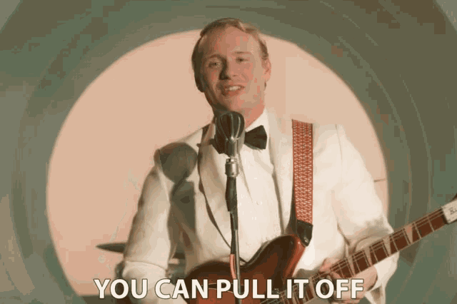a man singing into a microphone while holding a guitar with the words " you can pull it off " written below him