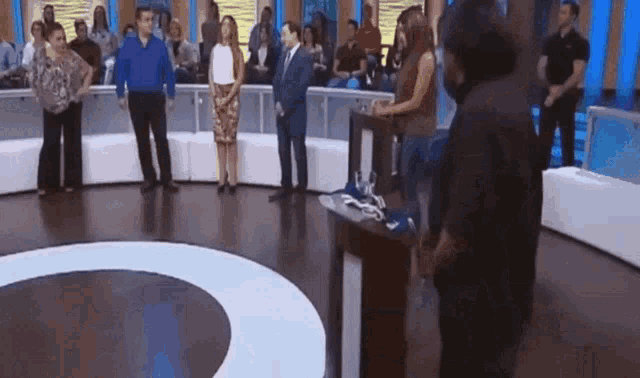 a group of people standing around a podium in a room