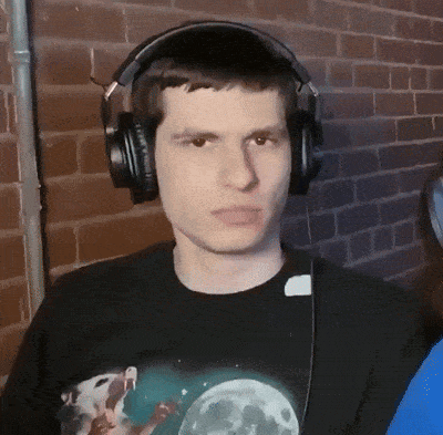 a man wearing headphones and a black shirt with a picture of the moon on it .