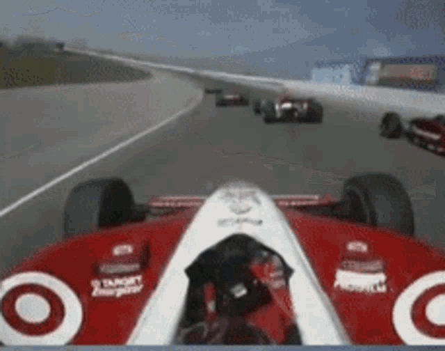 a red and white race car with a white target logo on the front