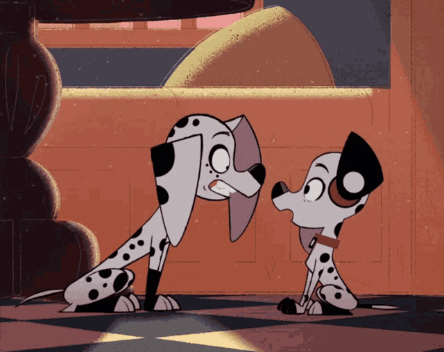 two dalmatian dogs are standing next to each other