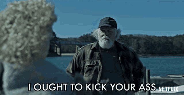 a man with a beard stands next to a woman and says i ought to kick your ass
