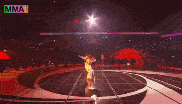 a woman is singing into a microphone on a stage while wearing a white jacket .